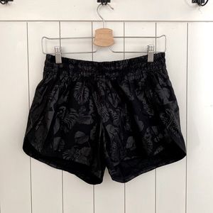 Black Athleta athletic shorts size small, shiny palm print